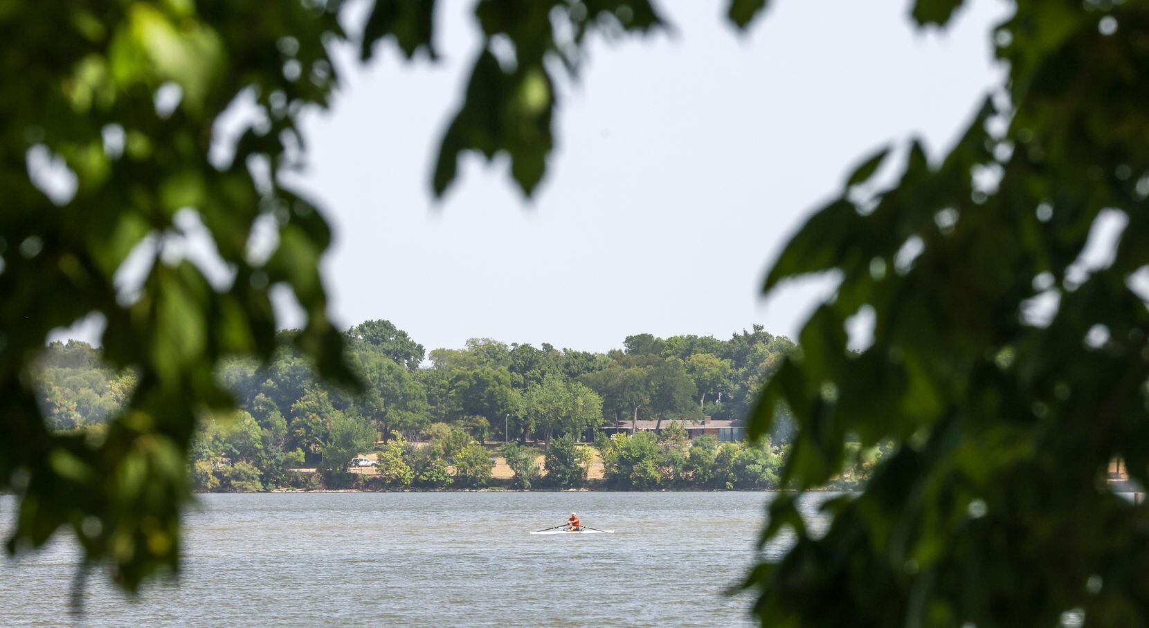 Bill Keros rowed on White Rock Lake in Dallas on Monday as area temperatures hit 109 degrees.