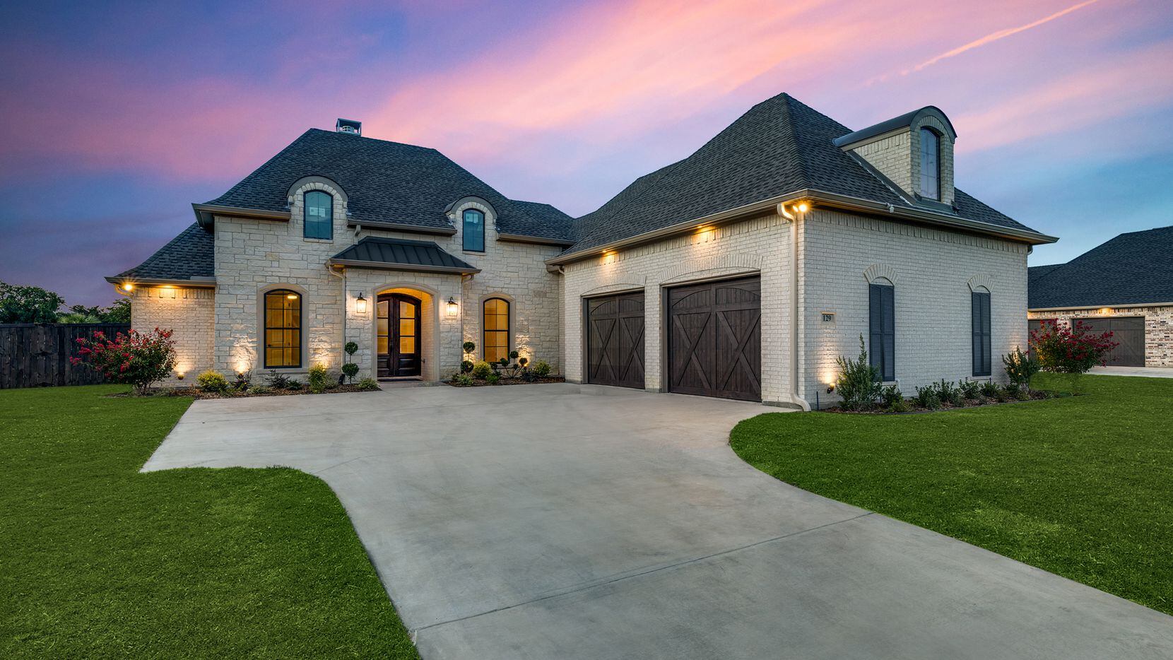 This custom residence is situated on a waterfront lot at 129 Old Bridge Road in Waxahachie’s...
