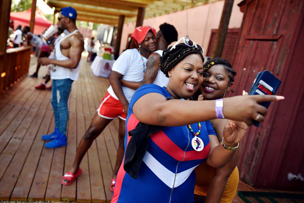 Ashley Williams (left) and her friend Tangela Lewis, both of Arkansas, snap a selfie during...