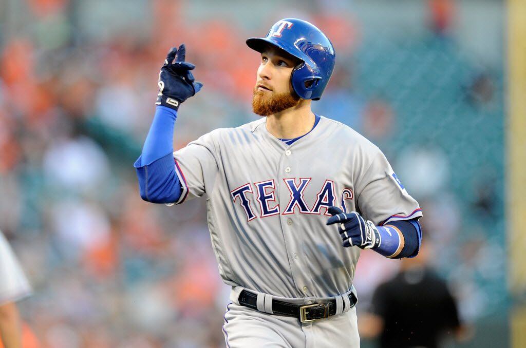 BALTIMORE, MD - AUGUST 04: Jonathan Lucroy #25 of the Texas Rangers celebrates after hitting...