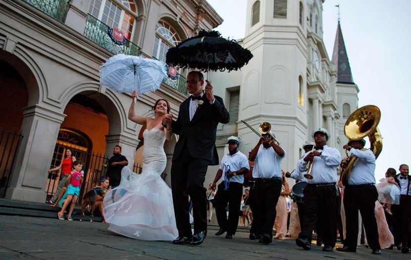Newlyweds dance their way out of St. Louis Cathedral at Jackson Square in the French Quarter...