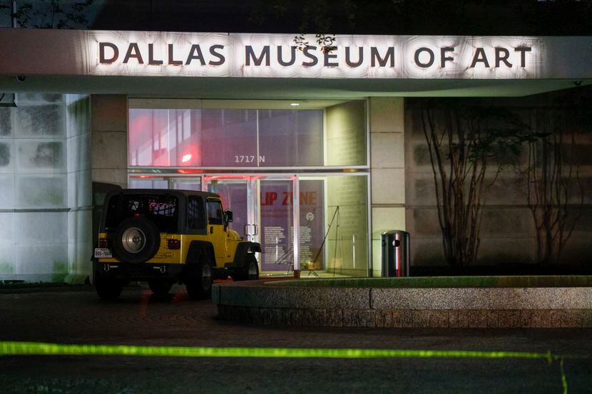 A Jeep sits in front of an entrance to the Dallas Museum of Art and behind police tape after...