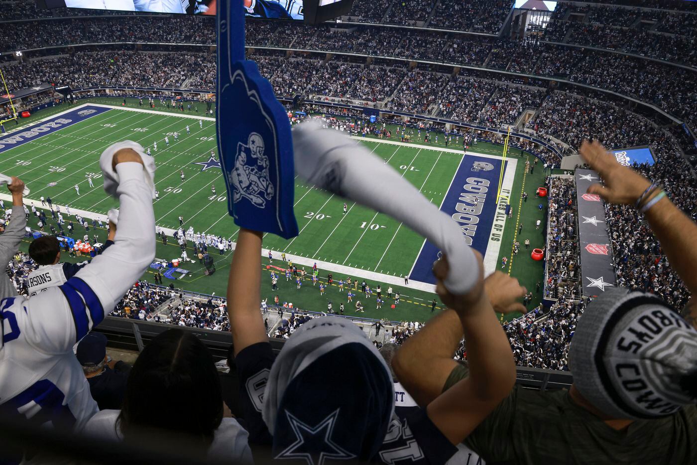 Dallas Cowboys fans cheer as Dallas lines up to kick after scoring and taking the lead in...