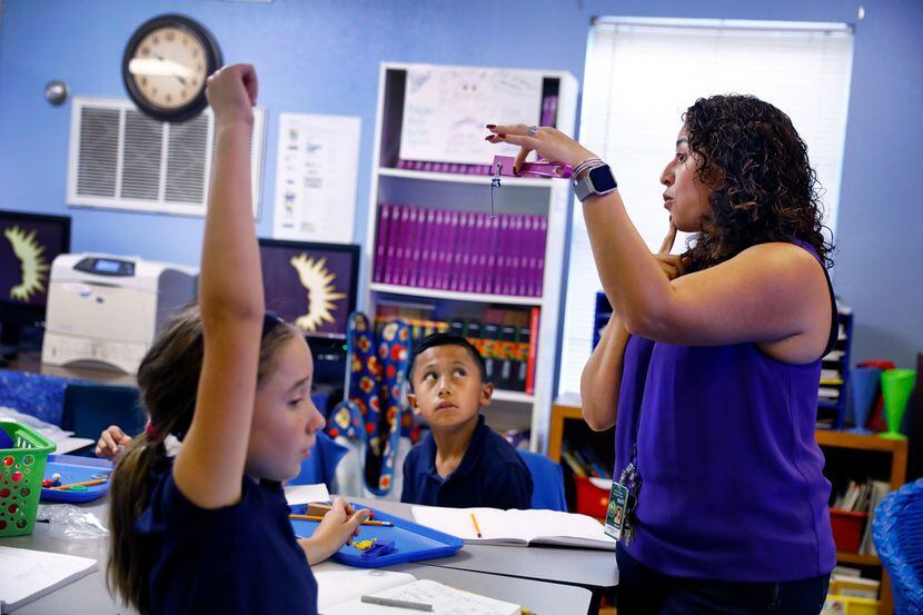 Third grade dual-language science teacher Carmen Arellano questions about magnetism at...