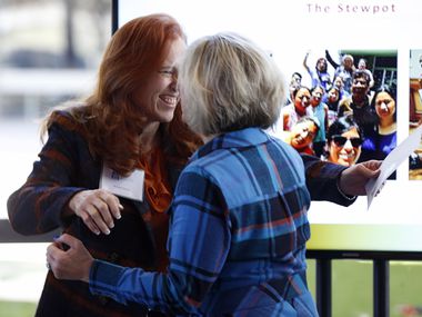 Brenda Snitzer of The Stewpot of First Presbyterian Church hugs Camille Grimes (right), executive director of The Dallas Morning News Charities after receiving a check during The Dallas Morning News Charities 2019-20 Campaign Kickoff Reception at Winspear Opera House in Dallas, on Thursday, Nov. 14, 2019.