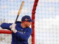 Texas Rangers catcher Mitch Garver waits for a pitch during batting practice in a spring...