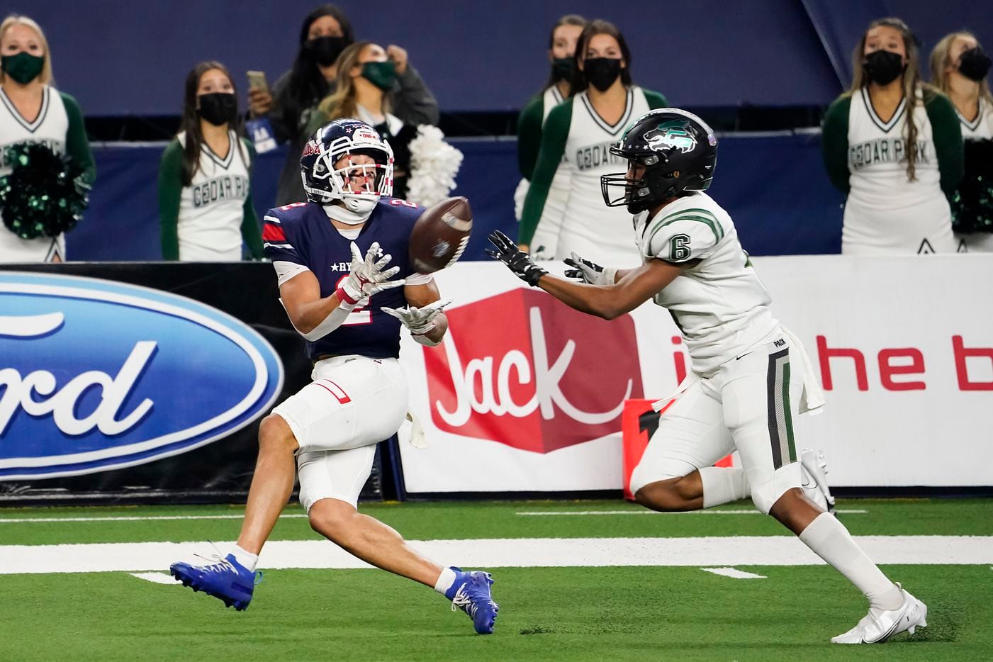 Denton Ryan Billy Bowman Jr. (2) hauls in a 37-yard touchdown pass from quarterback Seth Henigan as Cedar Park defensive back Michael Putney (6) defends during the first half of the Class 5A Division I state football championship game at AT&T Stadium on Friday, Jan. 15, 2021, in Arlington, Texas. (Smiley N. Pool/The Dallas Morning News)