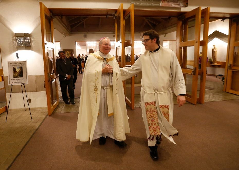 Bishop Edward Burns (left), the new bishop of Dallas, and Rev. Joshua Whitfield walk out of...