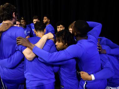 The Dallas Mavericks huddle in the tunnel before taking the court against the Golden State...