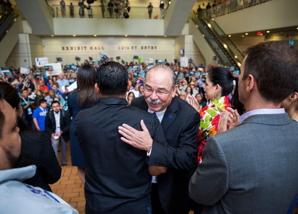 Gilberto Hinojosa gets a hug from a supporter after speaking during a Families First Rally...