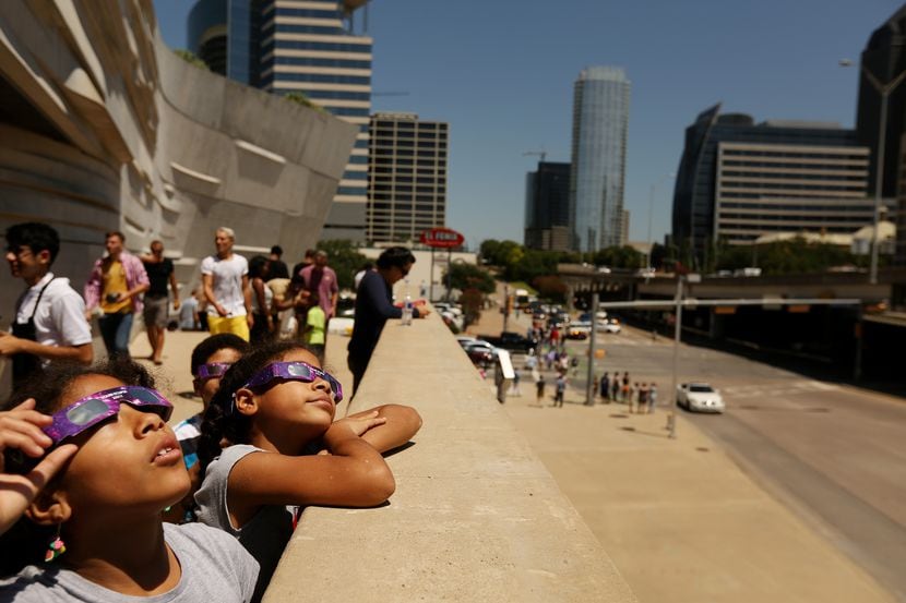 In this 2017 file photo, children watch a solar eclipse at the Perot Museum of Nature and...