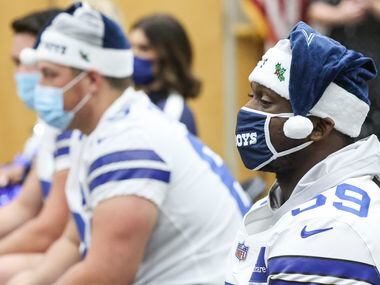 Dallas Cowboys linebacker Takkarist McKinley sits next to his teammates at Children's...