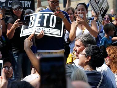 Democratic Presidential candidate Beto O'Rourke takes photos with fans before speaking at a...