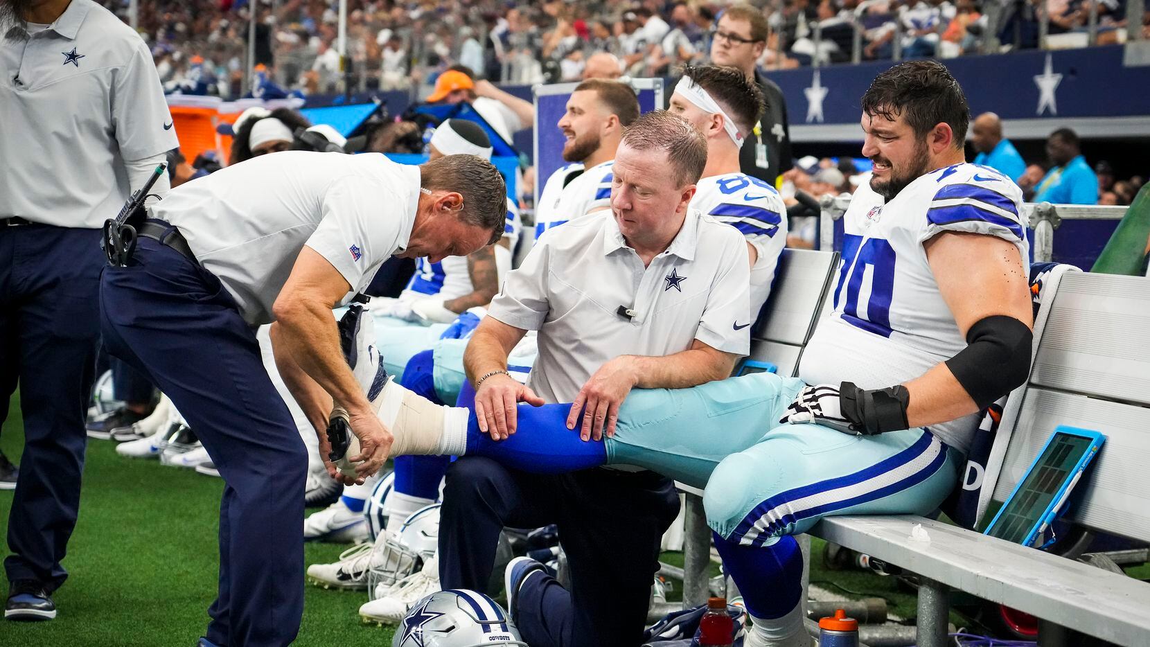 Dallas Cowboys guard Zack Martin has his ankle taped on the sidelines during the second half...
