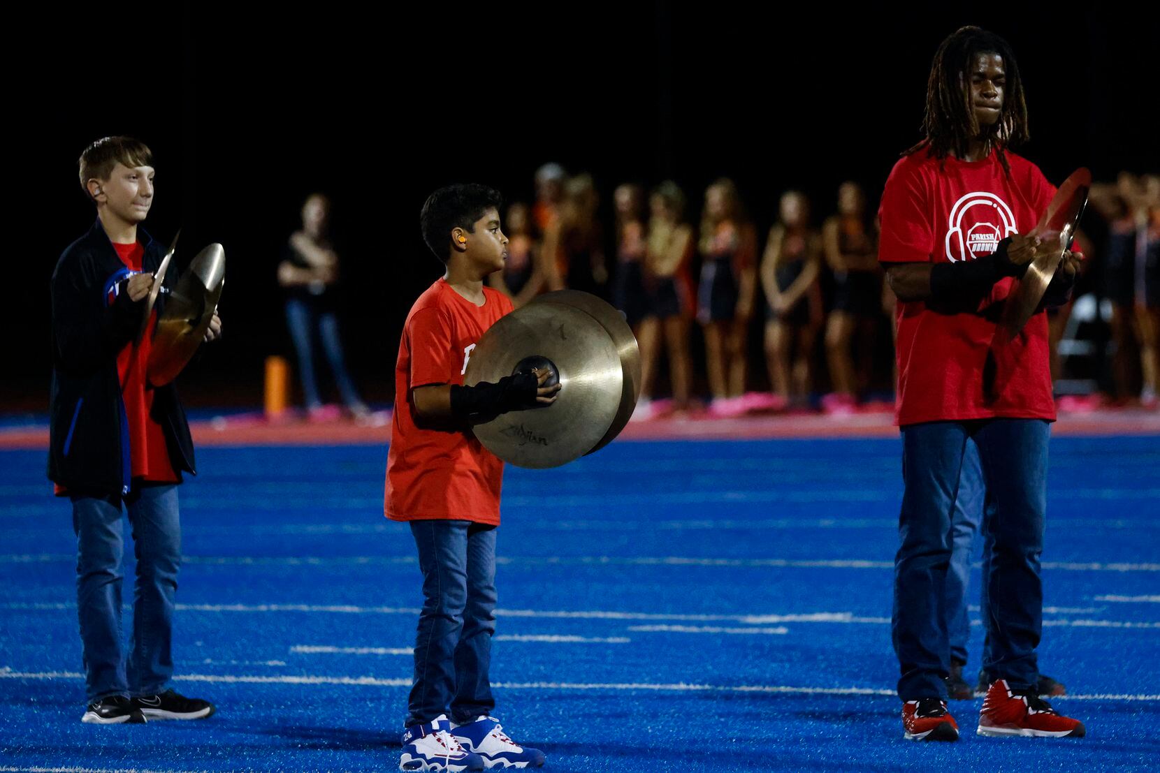 Parish Episcopal School’s Drumline performs during the halftime of a season-opening football...