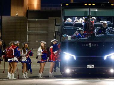 Parish Rosettes members line up to board the bus after performing at their football team’s...