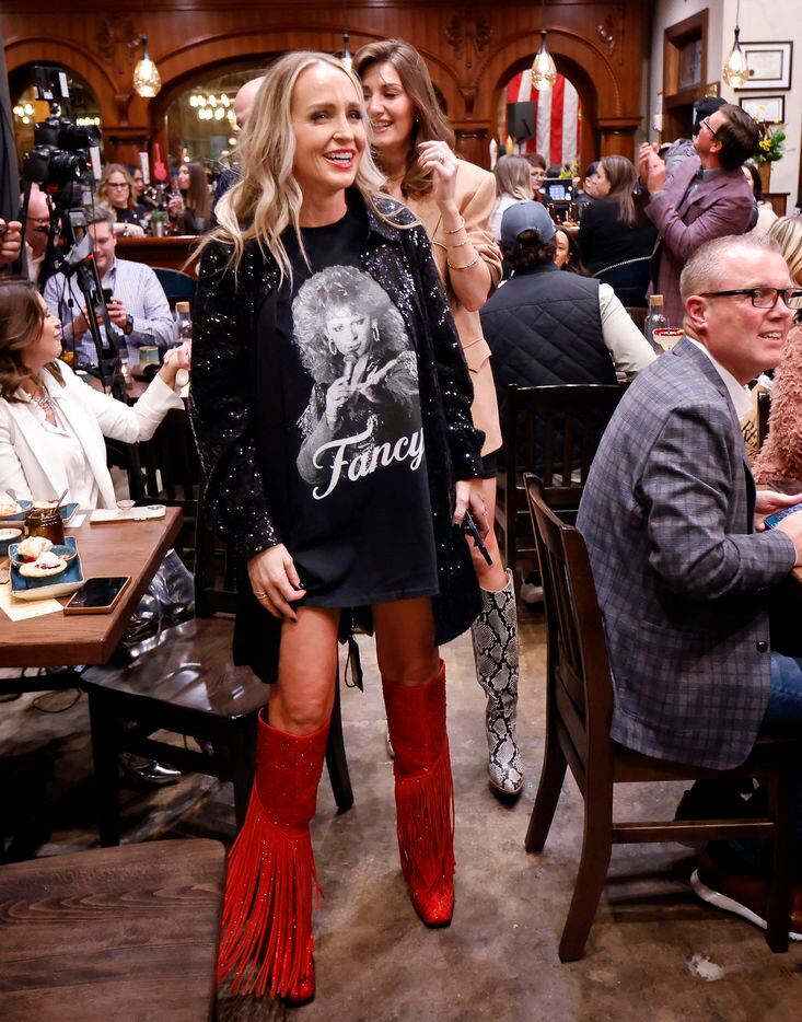 Influencer Carrie Jernigan wore a red-fringed cowboy boots and a Fancy t-shirt to country...