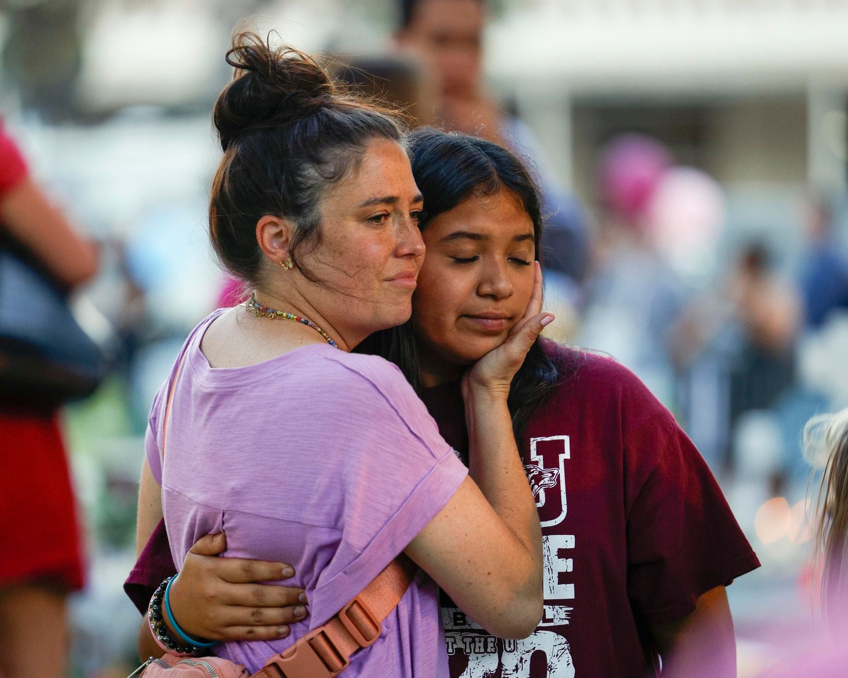 Columbine High School shooting survivor Lauren Bohn, 39, comforts Uvalde resident Aliseya...