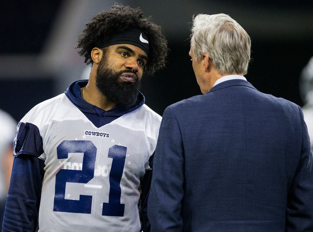 Dallas Cowboys running back Ezekiel Elliott (21) talks with Rich Dalrymple, senior vice president of public relations and communications, during a Dallas Cowboys OTA practice on Wednesday, May 22, 2019 at The Star in Frisco. (Ashley Landis/The Dallas Morning News)