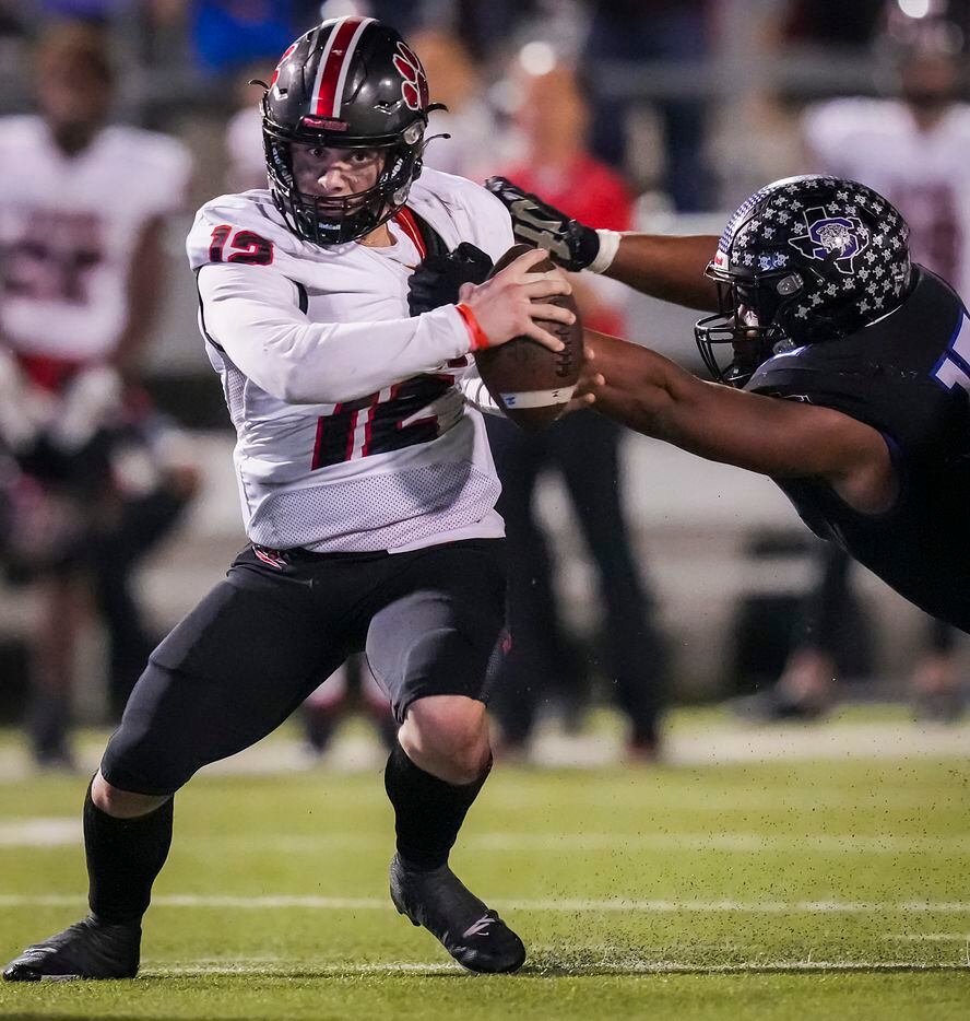 Colleyville Heritage quarterback Luke Ullrich (12) is brought down by Mansfield Summit defensive lineman Legend Journey (13) during the second half of the Class 5A Division I Region I final on Friday, Dec. 3, 2021, in North Richland Hills, Texas. (Smiley N. Pool/The Dallas Morning News)