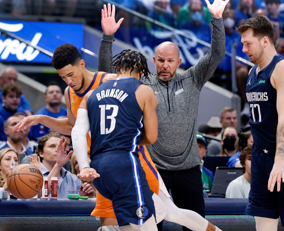 Dallas Mavericks head coach Jason Kidd reacts he’s as Phoenix Suns guard Devin Booker (1) is...