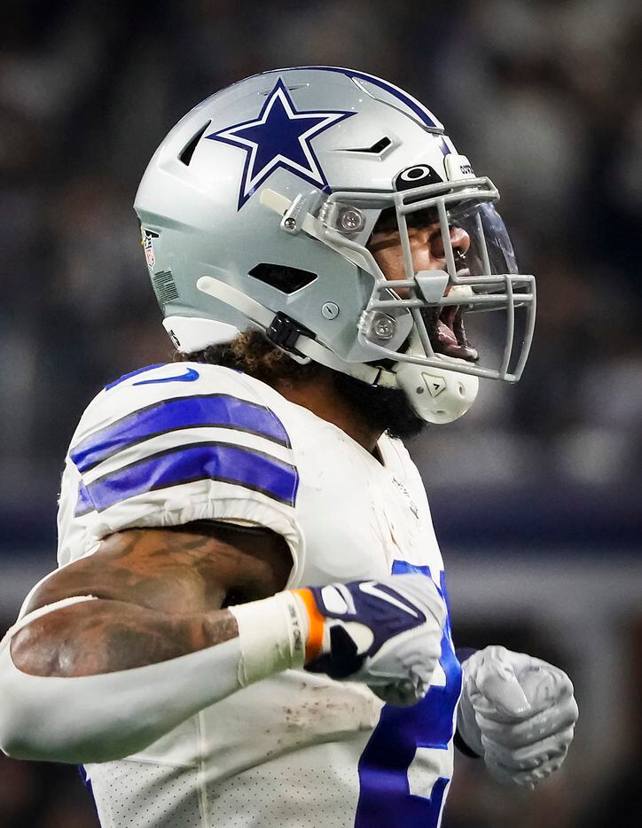 Dallas Cowboys running back Ezekiel Elliott (21) celebrates after scoring a touchdown during the first half of an NFL football game against the Washington Football Team at AT&T Stadium on Sunday, Dec. 26, 2021, in Arlington.