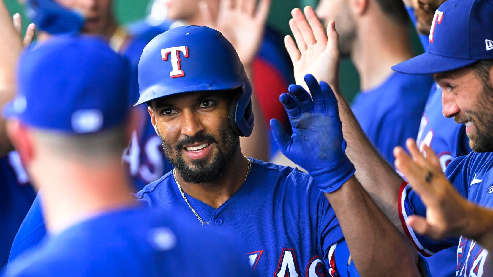 Texas Rangers' Marcus Semien is congratulated after hitting a three-run home run during the...