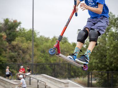 Johnny Shaffer rides his scooter during family night at The Edge Skate Park in Allen. Many...