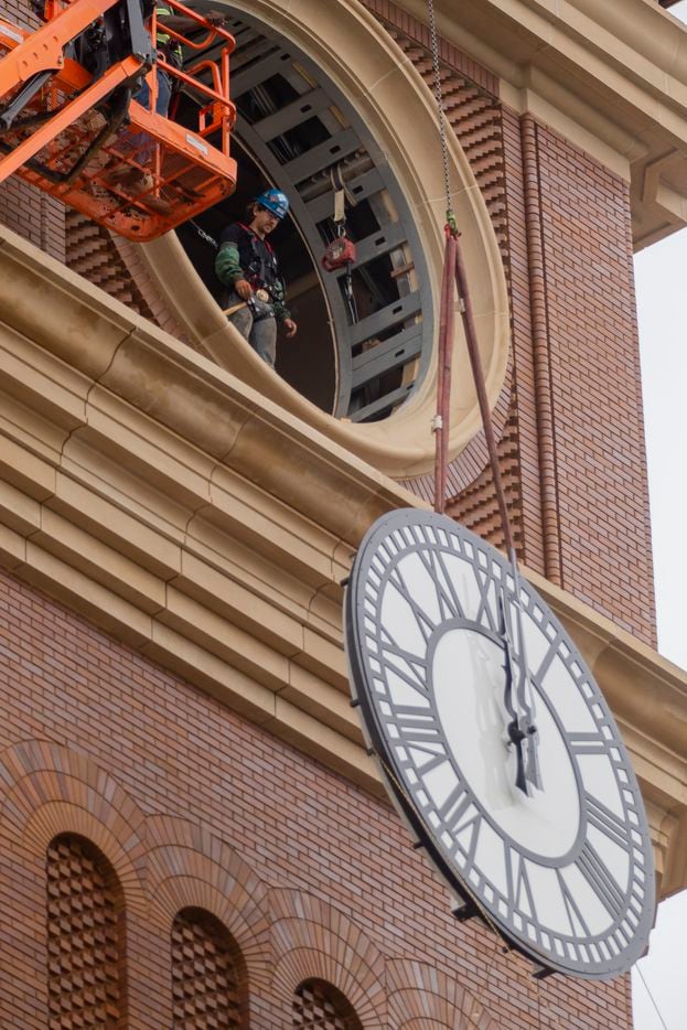 Workers from MEI Rigging & Crating work to install a 12-foot glass clock on the Grapevine Main Station’s Observation Tower on Sept. 3, 2020 in Grapevine. The clocks designed by Electric Time Company were designed to be compatible with the Texas-Italianate style of the station. (Juan Figueroa/ The Dallas Morning News)