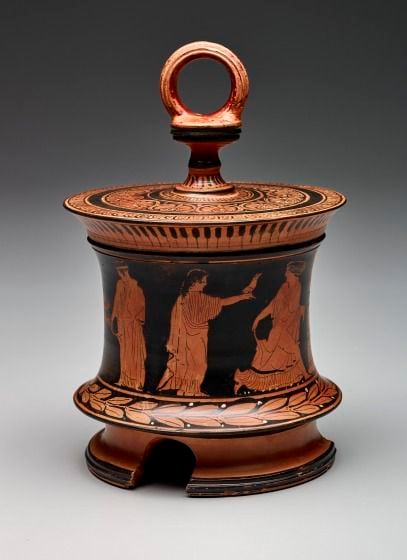 A red-figure pyxis and lid from the last half of 5th century B.C. B.C. is among three...