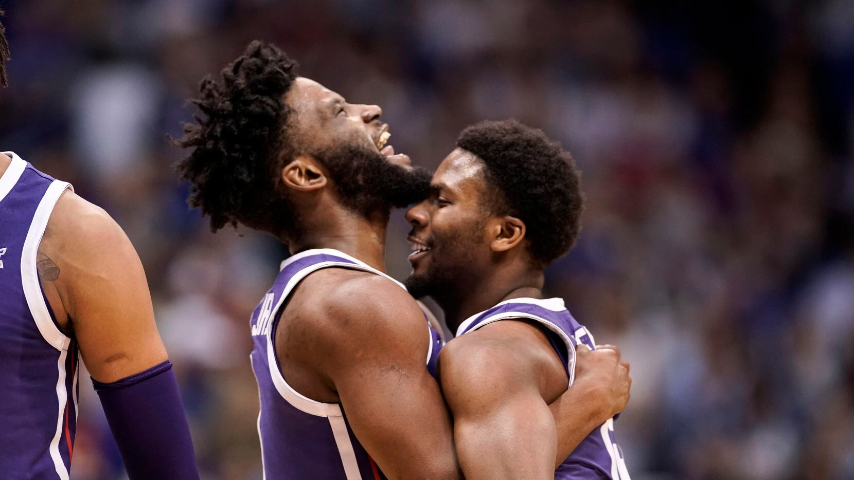TCU guards Mike Miles Jr., left, and Shahada Wells (13) embrace during a timeout in the...