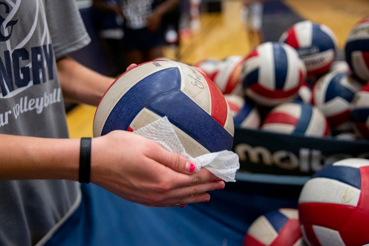 Volleyballs are sanitized after Flower Mound High School volleyball players finish practice...