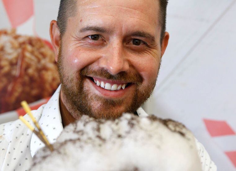 Justin Martinez holds up a Cotton Candy Taco, named Most Creative State Fair food in the...