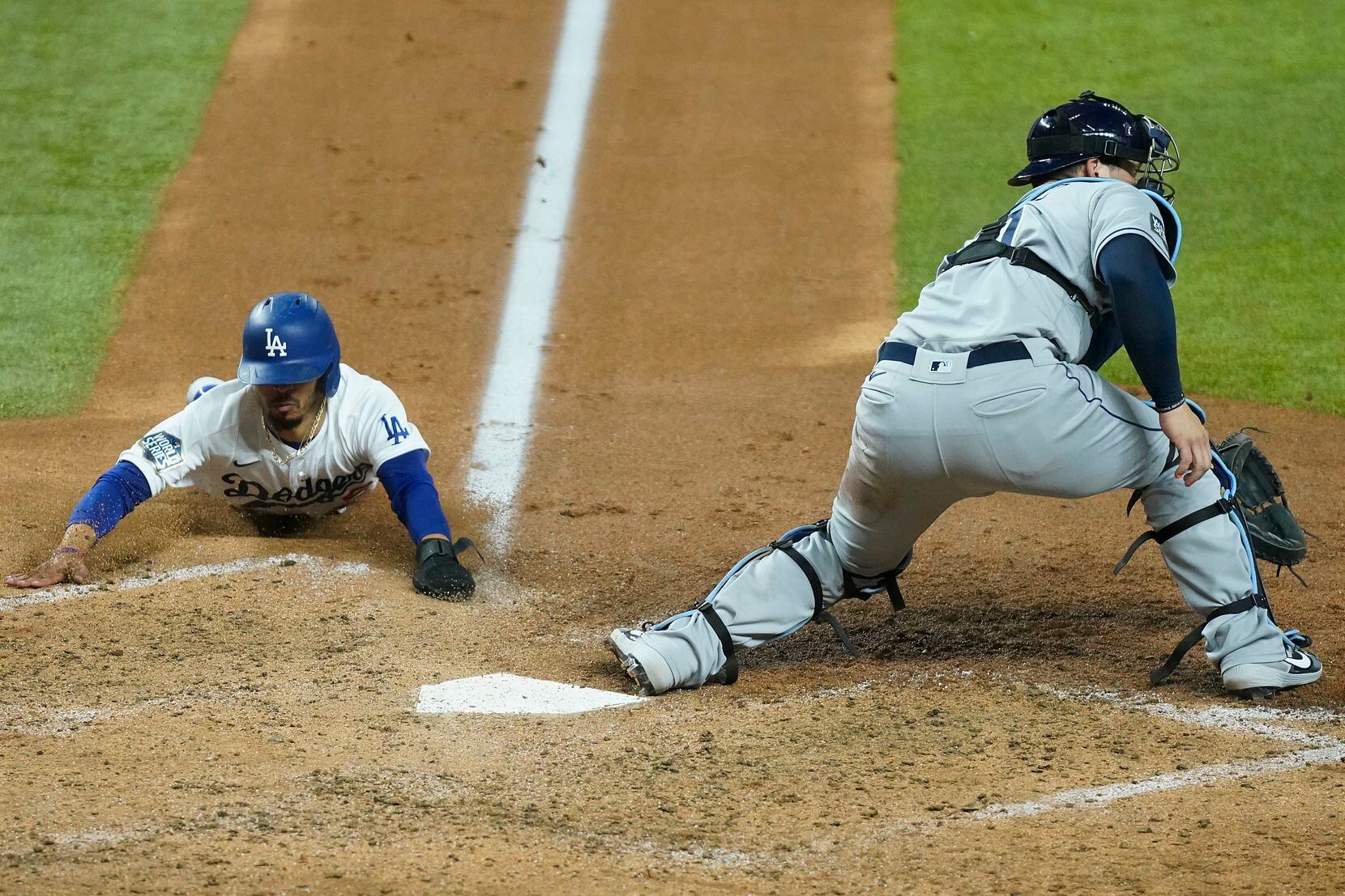 Los Angeles Dodgers right fielder Mookie Betts (50) scores past Tampa Bay Rays catcher Mike...