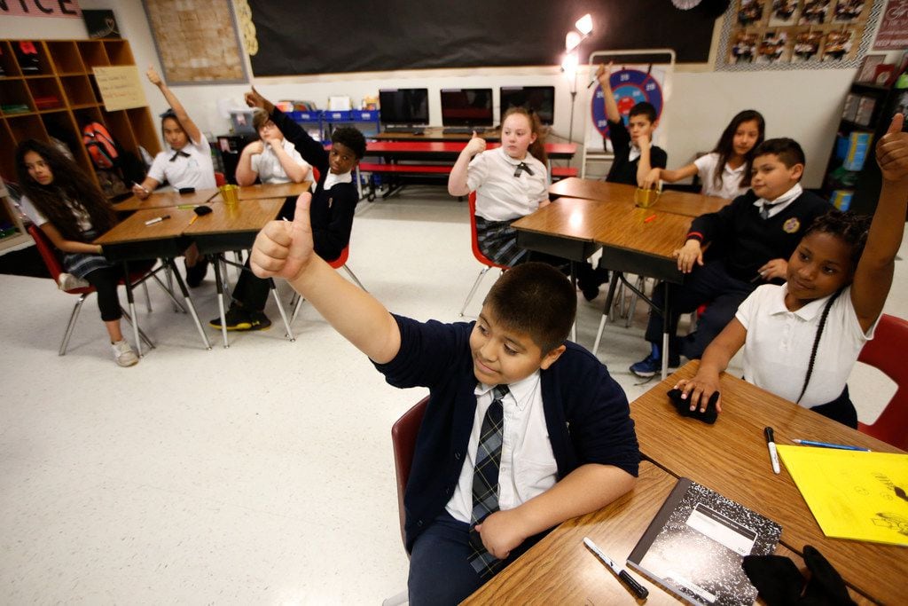 Adrian Torres gives the thumbs-up to a correct answer during his fifth-grade math class at...