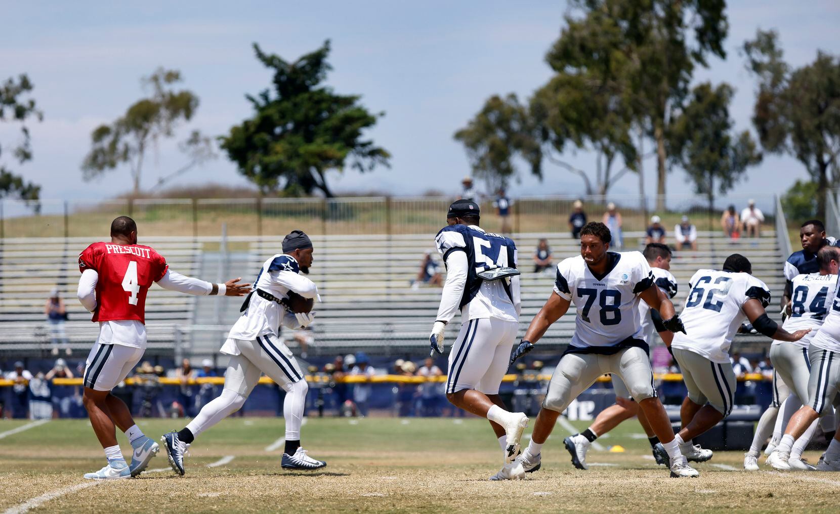 Dallas Cowboys quarterback Dak Prescott (4) hands off to running back Tony Pollard (20)...