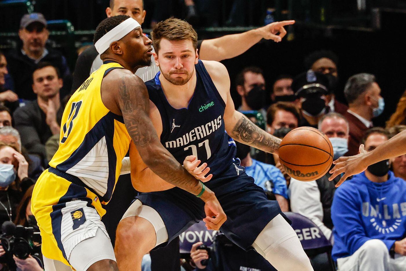 Dallas Mavericks guard Luka Doncic (77) drives to the basket as Indiana Pacers forward Torrey Craig (13) tries to block him during the first half at the American Airlines Center in Dallas on Saturday, January 29, 2022.