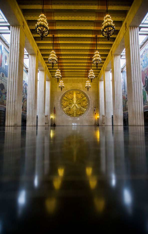 A large gold seal and murals decorate the inside of the historic Hall of State building on...