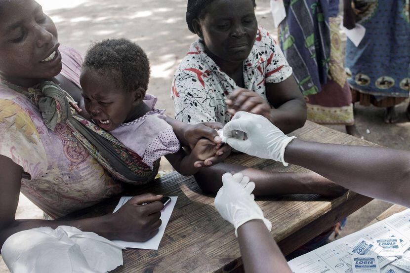 
Malawians go through a medical checkup by a paramedic from a non-governmental organisation...