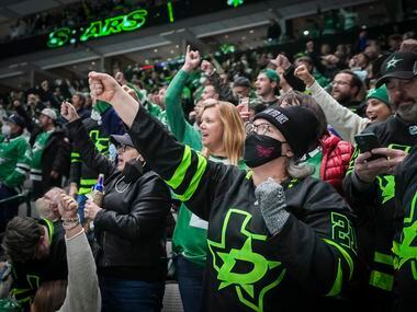 Dallas Stars fans celebrate a goal by left wing Michael Raffl during the first period of an...