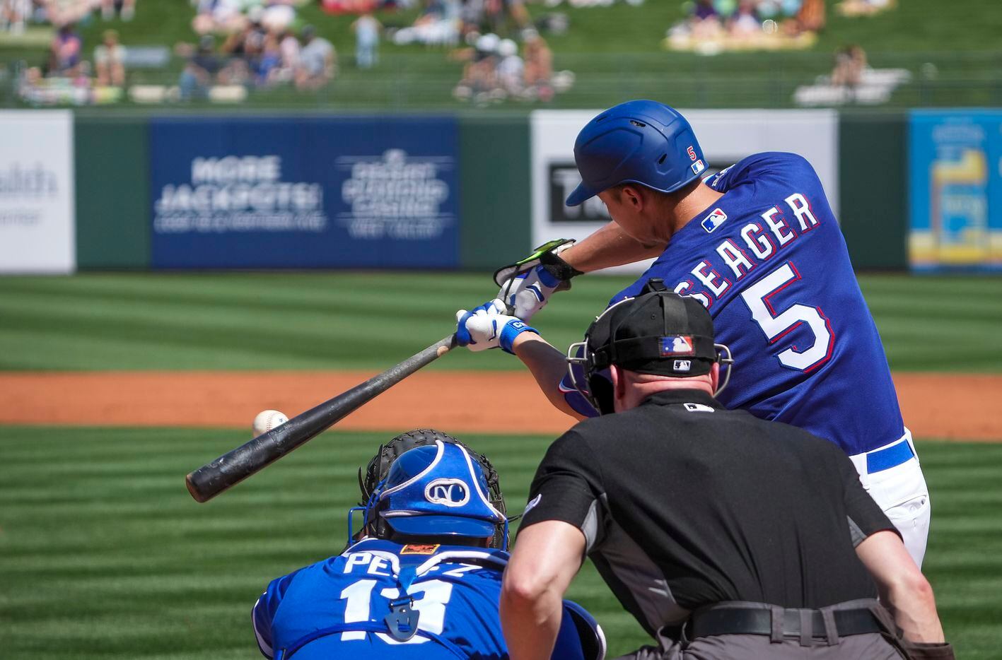 Texas Rangers infielder Corey Seager connects on a single in his first spring training game...