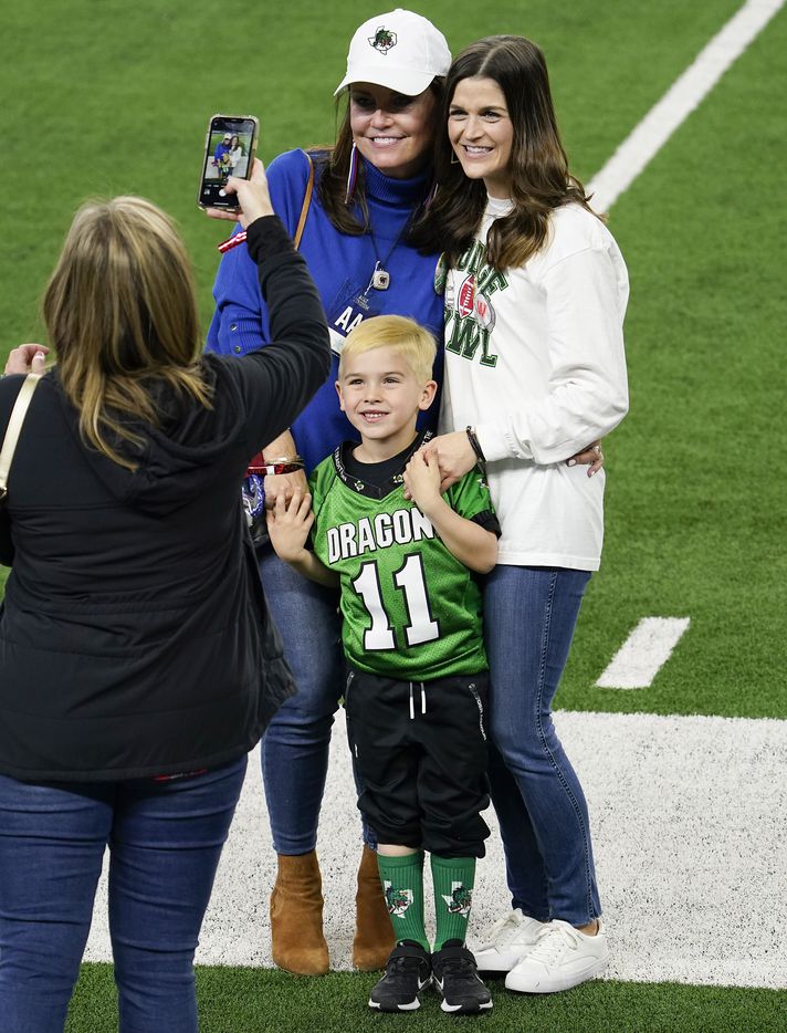 Elizabeth Dodge poses on the field with her grandson Tate, 5, and daughter-in-law Alexis Dodge as the teams warm up before her husband, Austin Westlake head coach Todd Dodge face off against her son, Southlake Carroll head coach Riley Dodge in the Class 6A Division I state football championship game at AT&T Stadium on Saturday, Jan. 16, 2021, in Arlington, Texas. (Smiley N. Pool/The Dallas Morning News)
