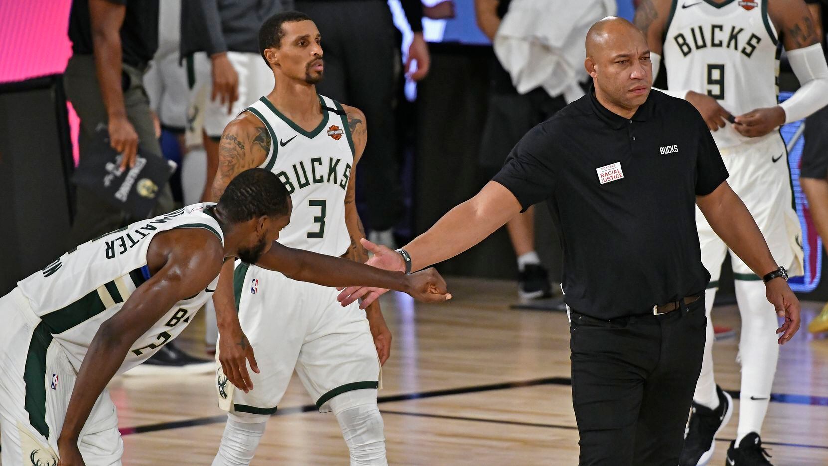Assistant Coach, Darvin Ham of the Milwaukee Bucks high fives a player during the game...