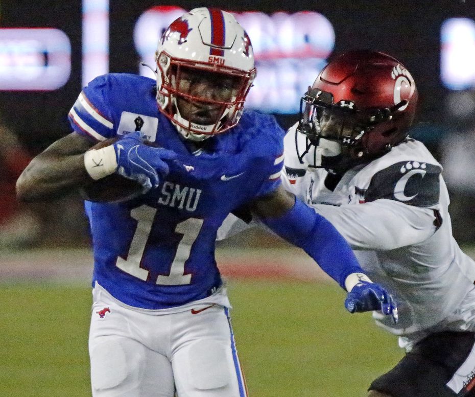 SMU wide receiver Rashee Rice (11) is pushed out of bounds by Cincinnati linebacker Jarell White (8) after a catch in the first half of an AAC game at Ford Stadium in Dallas on Saturday, Oct. 24, 2020.