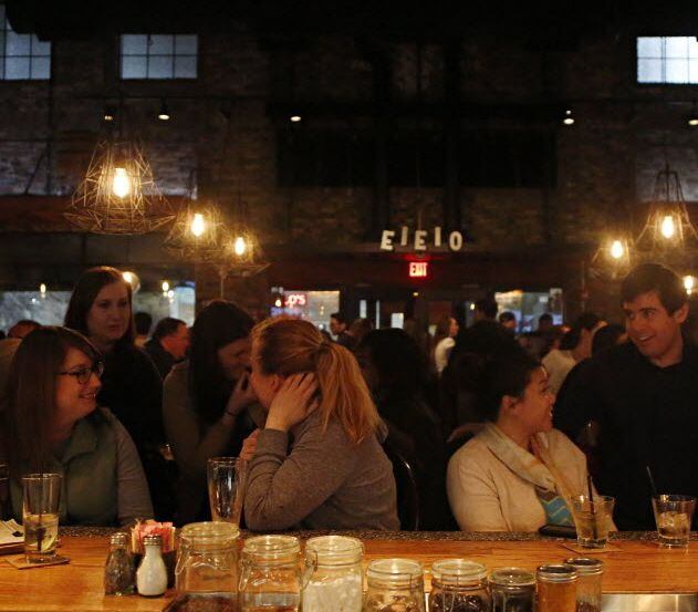 Customers line the bar at Whiskey Cake Kitchen & Bar shot Wednesday, February 20, 2013 in...