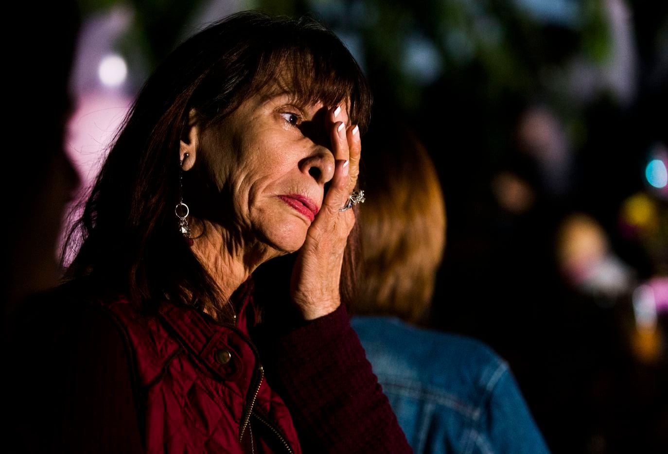 Linda Robinson wipes away a tear during a vigil for Sherin in Richardson.