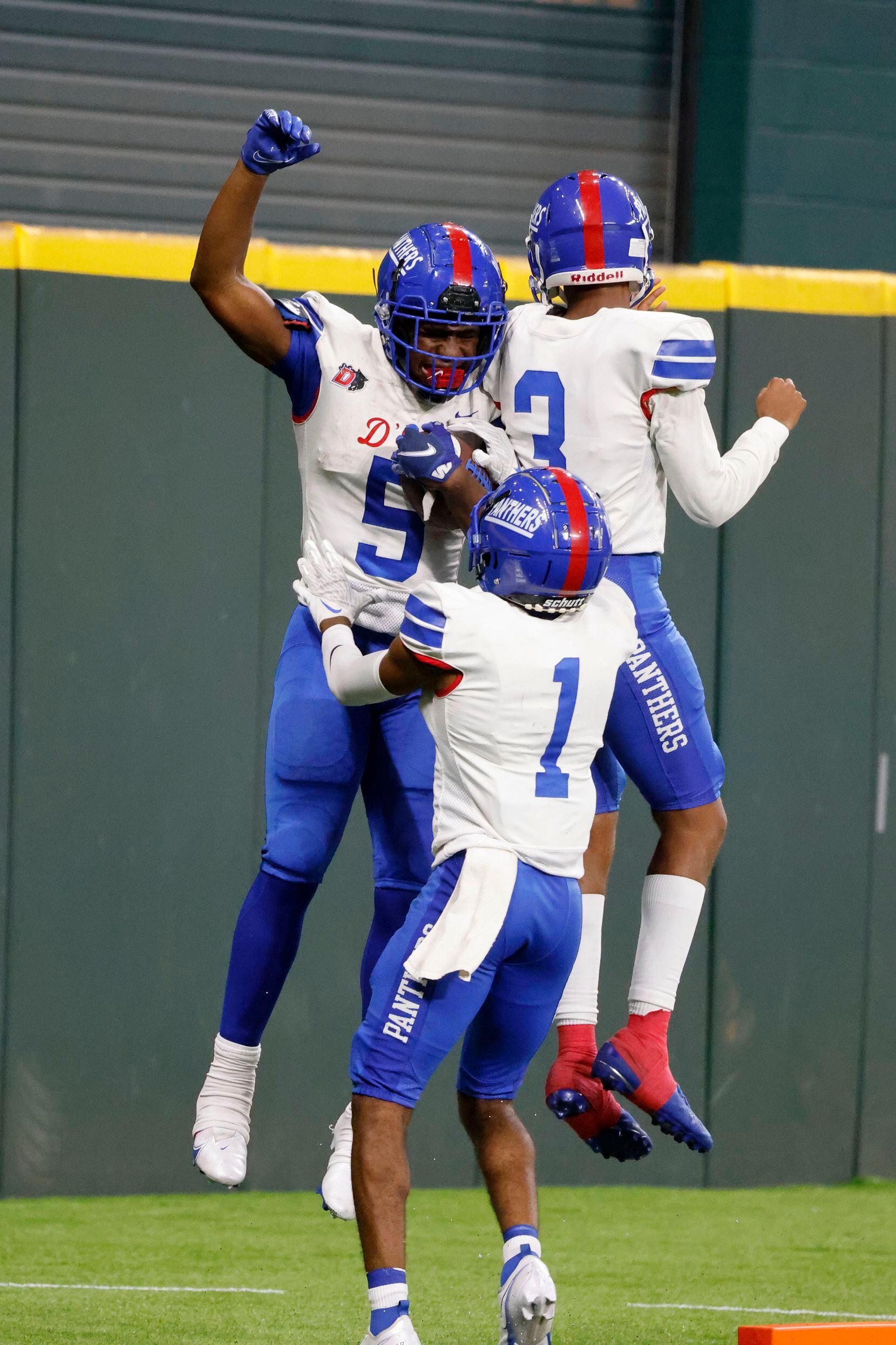 Duncaville’s Malachi Medlock (5) celebrates a touchdown with Lontrell Turner (1) and Solomon...