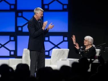 Southwest Airlines president emeritus Colleen Barrett, right, attempts to calm an applauding...