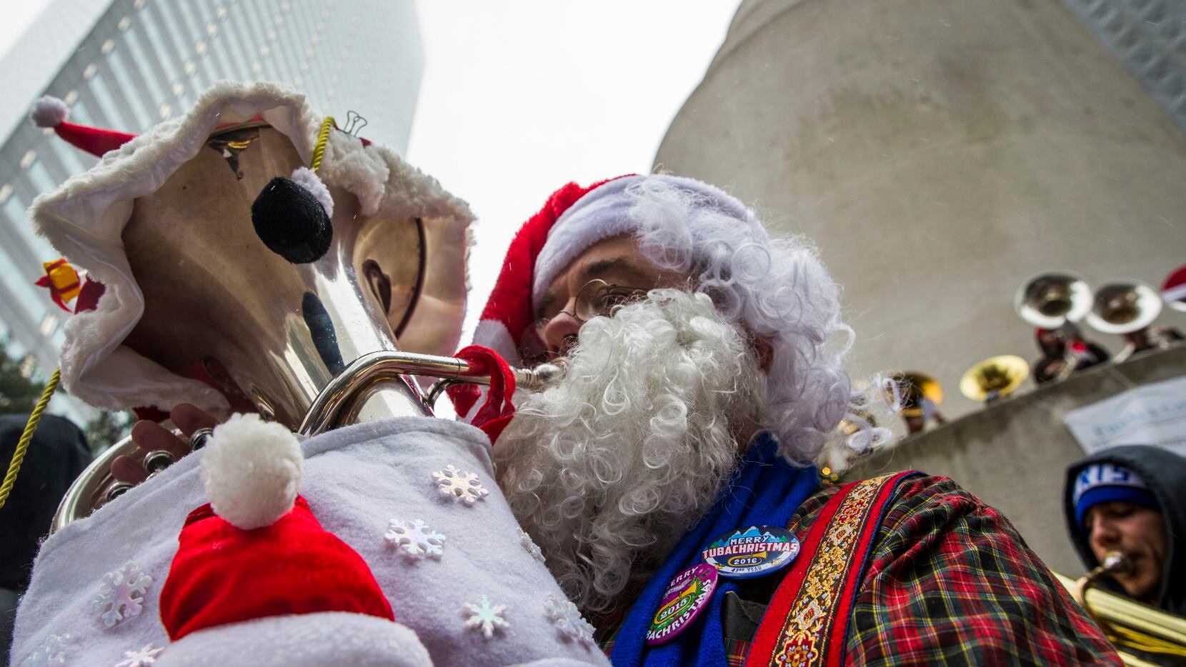 Warren Brooks, who is dressed as Santa Claus, performs with over 250 other tuba, sousaphone and euphonium players during the 39th annual Tuba Christmas on Friday, December 23, 2016 at Thanksgiving Square in downtown Dallas. (Ashley Landis/The Dallas Morning News)