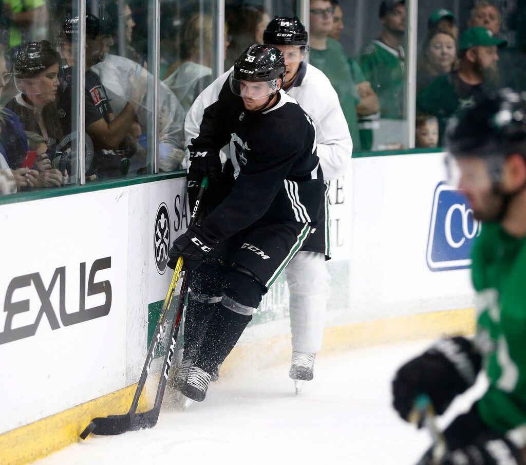 Dallas Stars Tanner Kero attempts to take the puck away from Dallas Stars Emil Djuse (33)...